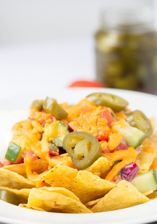 Close up of nachos with spicy salsa.