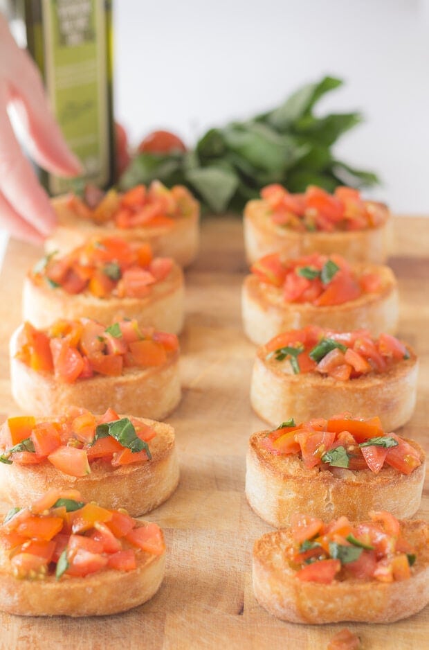 Mini bruschetta with cherry tomatoes and basil makes for a quick, delicious and easy to make starter, lunch or snack. This is a brilliant cheap and healthy traditional recipe that you'll just love!