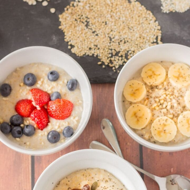 Birds eye view of 3 different types of cooked breakfast porridges. Porridge oats, oatmeal and pinhead oats.