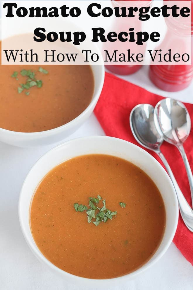 Birds eye view of two bowls of tomato zucchini soup with pin title at the top.
