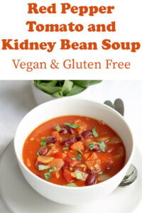 A vibrant bowl of red pepper tomato and kidney bean soup.