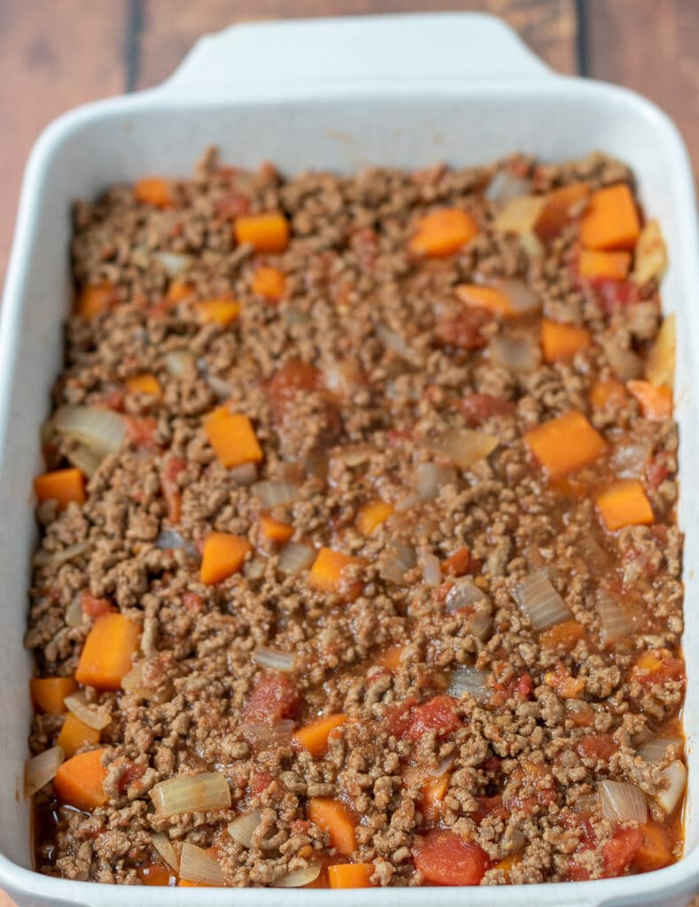 Cumberland pie mince mixture spooned into an oven proof casserole dish.