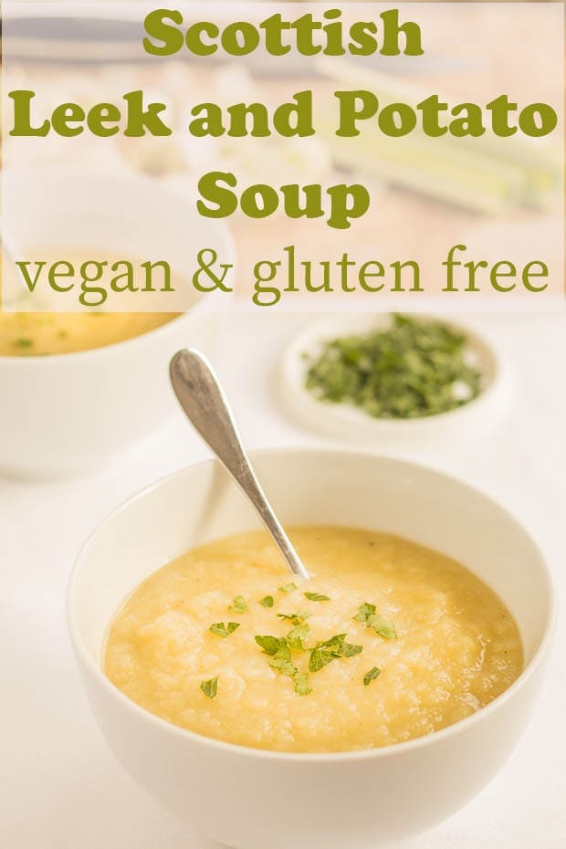 Two bowls of scottish leek and potato soup with serving spoons in garnished with fresh parsley.