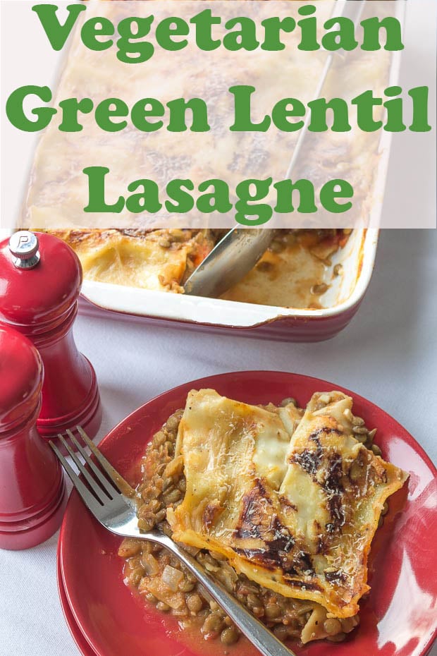 Green lentil lasagne served on a plate with serving dish behind it.