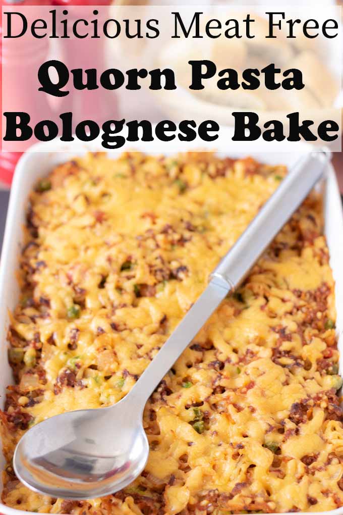 Dish of quorn pasta bolognese bake just removed from oven with spoon sitting diagonally on it.