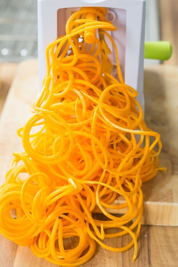 Spiralized butternet squash being made in a spiralizer.