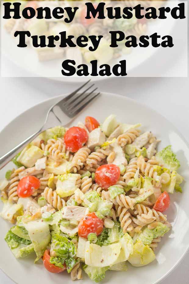 Honey mustard turkey pasta salad on a plate with a fork. Pin title text overlay at top.