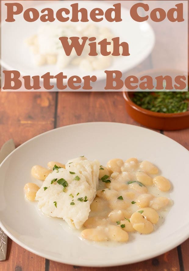 Two plates with poached cod with butter beans served on.