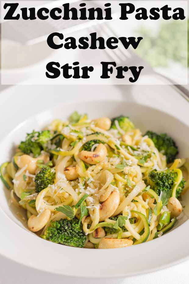 A bowl of zucchini pasta cashew stir fry. Pin title text overlay at top.