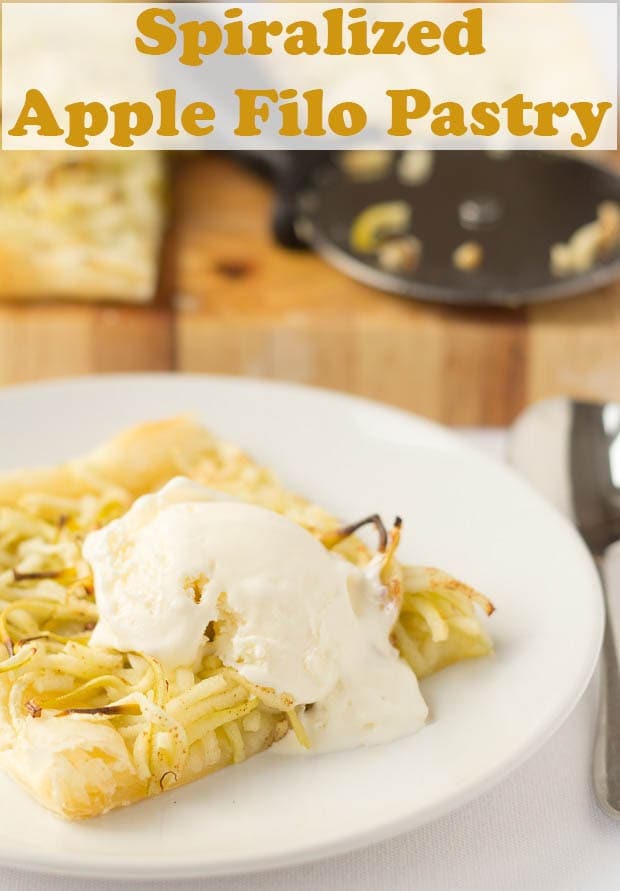Spiralized apple filo pastry on a plate with a blog of ice cream melting on top.
