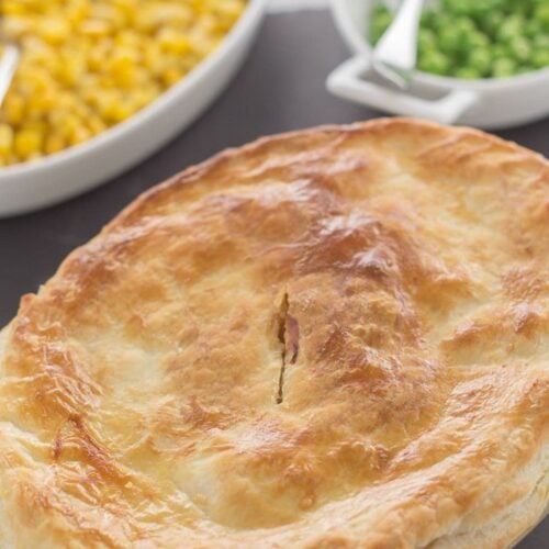 Turkey and leek pie at the bottom with side dishes of sweetcorn and peas at the top.
