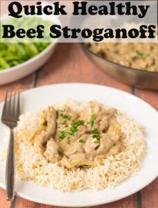 A plate of quick healthy beef stroganoff served on a bed of rice, garnished with chopped parley and a fork to the side. Pin title text overlay at top.