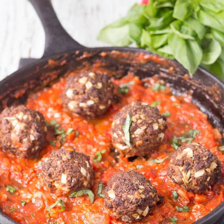 Quorn meatballs in a skillet in tomato sauce.