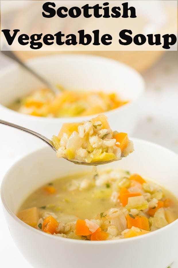 Two bowls of Scottish vegetable soup one in front of the other. A spoonfull of vegetable soup being lifted out of the front bowl.