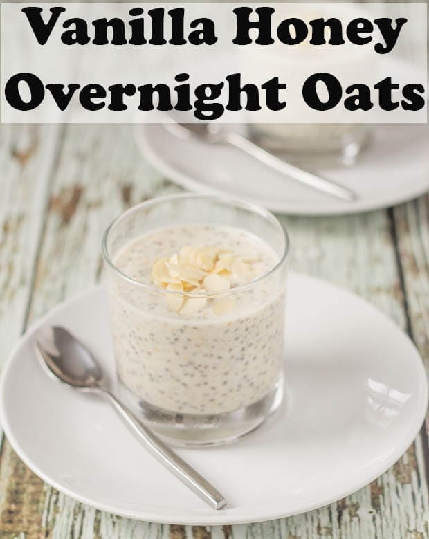 Vanilla honey overnight oats in a glass on a white plate with a teaspoon ready to eat.