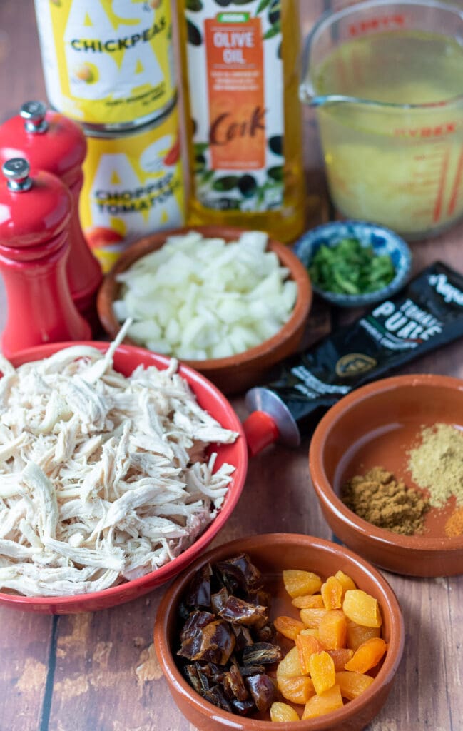 Moroccan chicken soup ingredients laid out on a table.