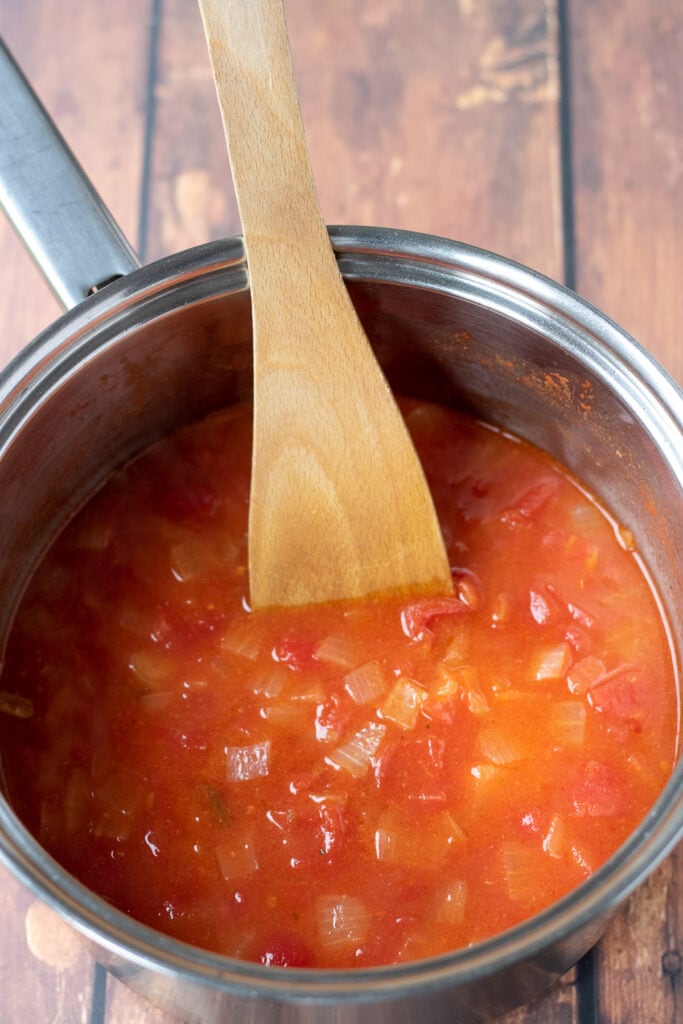 Chopped tomatoes, tomato puree, chicken stock and apricots added to diced onion.