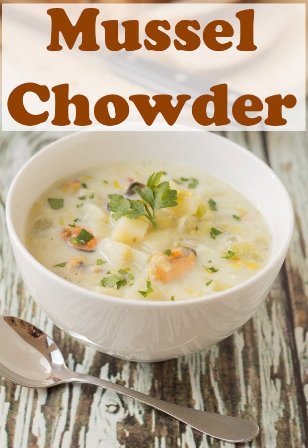 A bowl of seafood mussel chowder with a soup spoon beside. Pin title text overlay at top.