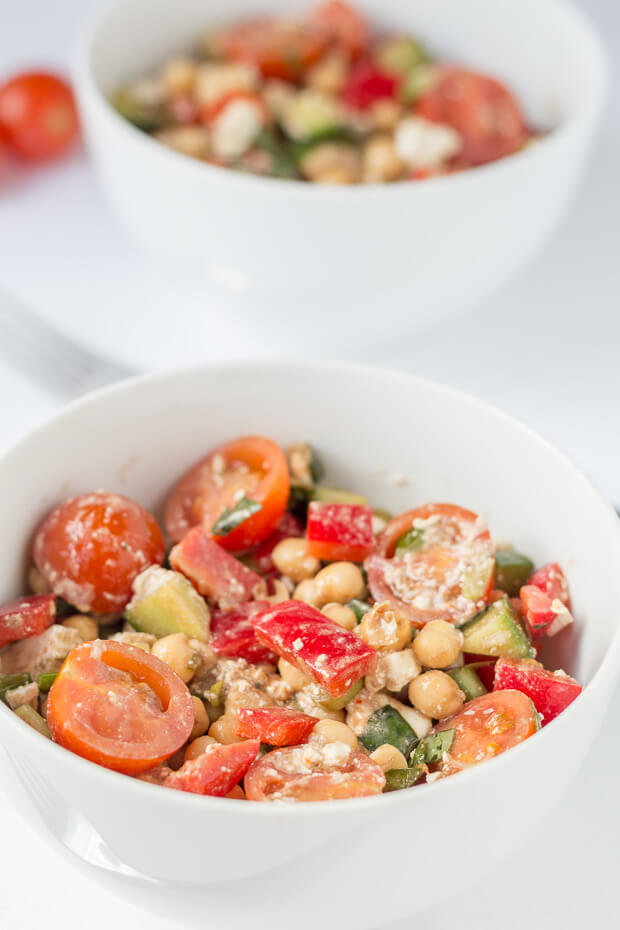Two bowls of Mediterranean chickpea salad one in front of the other.