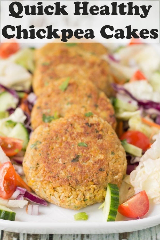 Four quick healthy chickpea cakes arranged on a platter dish surrounded by a salad. of lettuce, cucumber abd sliced tomatoes. Pin title text overlay at top.