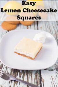 One easy lemon cheesecake square placed on a plate with a fork in front ready to eat.