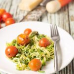 Courgette spaghetti with tomatoes and homemade pesto is a delicious and simple recipe. It's perfect for beginners to get to grips with how to make courgette spaghetti. You’ll soon be using that spiralizer like professional in no time at all!