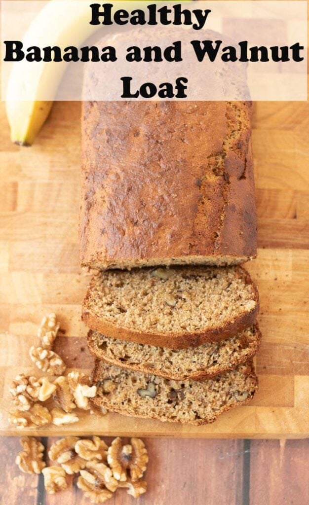 Birds eye view of healthy banana and walnut loaf on a chopping board with 3 slices cut off.