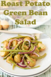 A plate with roast potato and green bean salad on. Pin title text overlay at top.