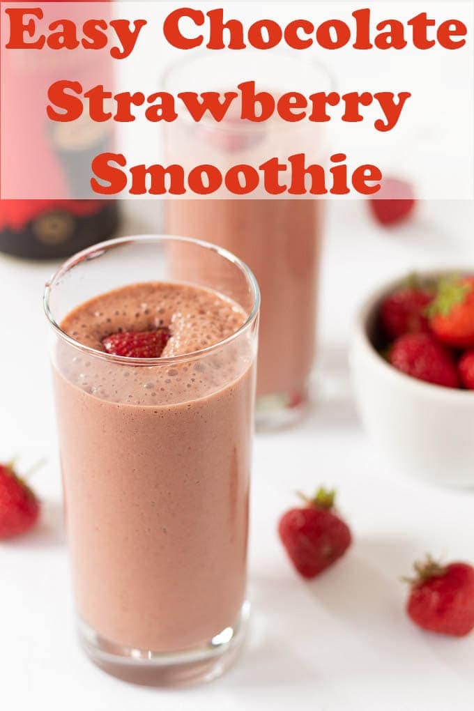 Two large glasses of chocolate strawberry smoothie one in front of the other.