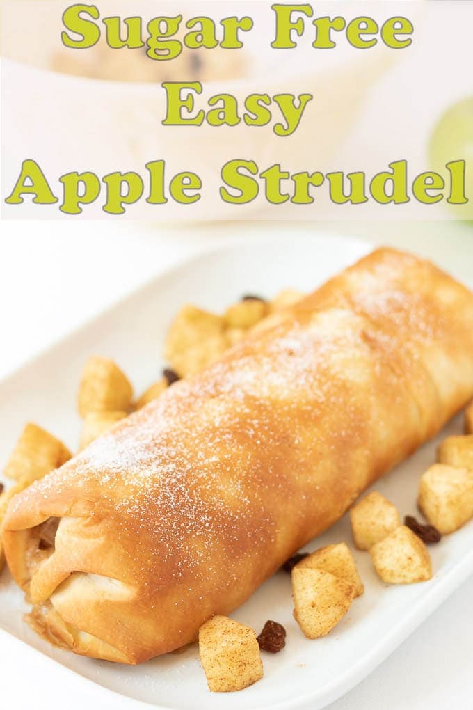 Sugar free easy apple strudel laid on a white serving dish decorated with a border of chopped apples and sultanas.