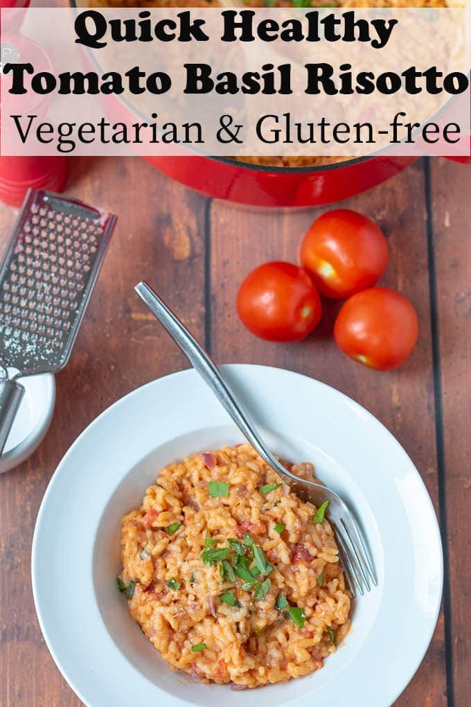 Bowl of delicious creamy tomato and basil risotto served with a fork ready to eat.