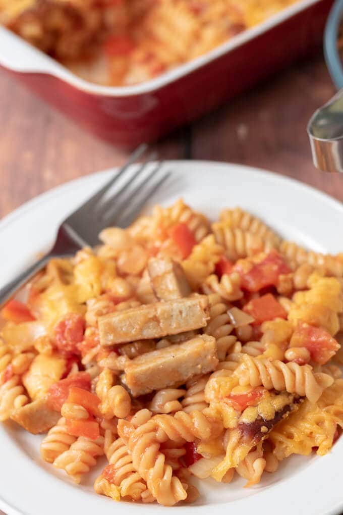 Close up of served plate of sausage pasta bake with baked beans. Delicious and ready to eat!