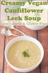 Two delicious bowls of creamy vegan cauliflower leek soup garnished with chives.