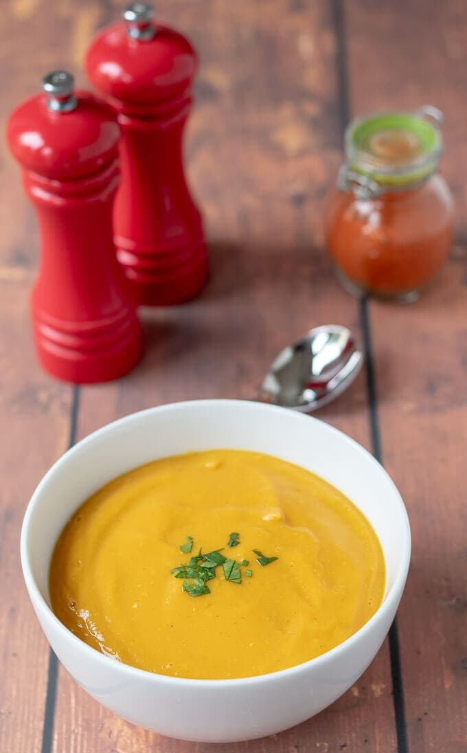 View of a bowl of delicious and filling sweet potato and red lentil soup served and ready to eat.