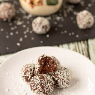 A plate of delicious mums no bake chocolate snowballs piled up and ready to eat!