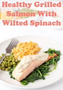 Healthy grilled salmon with wilted spinach. Looking for an easy meal with salmon? Try this recipe! It tastes amazing and includes a simple lower fat sauce. #neilshealthymeals #recipe #dinner #grilled #salmon