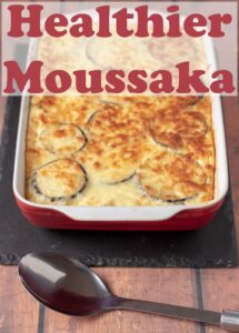 Healthier Moussaka just taken out of the oven and cooling before being carved up and served. Pin title text overlay at top.