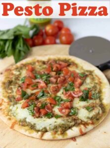 Pesto pizza with cherry tomato and basil salad makes for a delicious change from a normal pizza. It's a quick to make cheats pizza ideal for when you're short on time! #neilshealthymeals #recipe #pesto #pizza