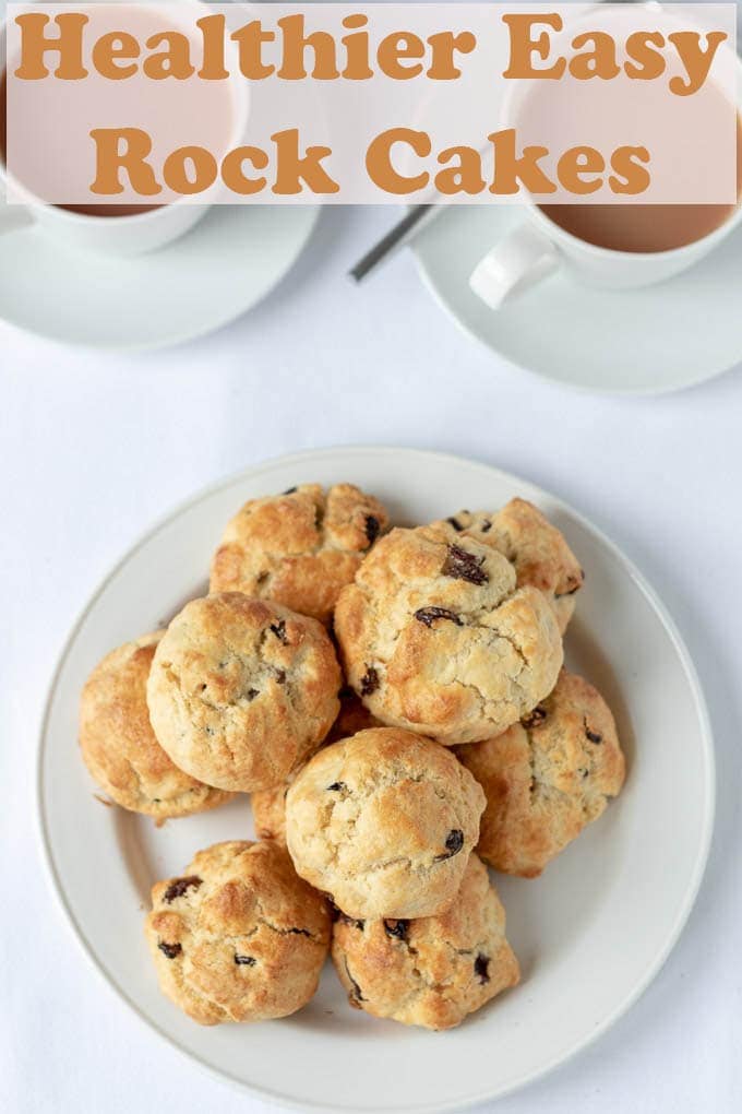Birds eye view of a plate of 8 rock cakes and two cups of tea.