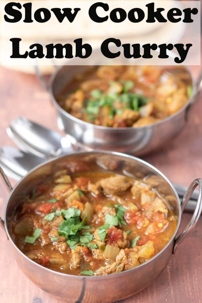 Two balti dishes of slow cooker lamb curry one in front of the other with serving spoons in between.