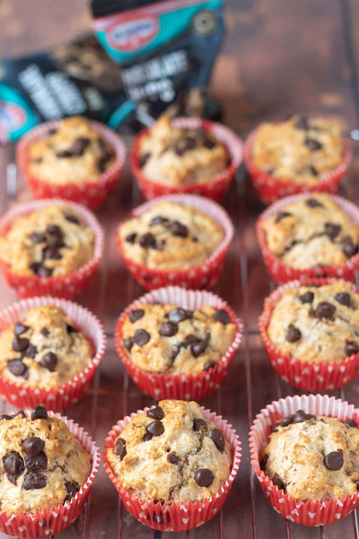 A baking rack of 12 sugar free wholemeal muffins with chocolate chips.