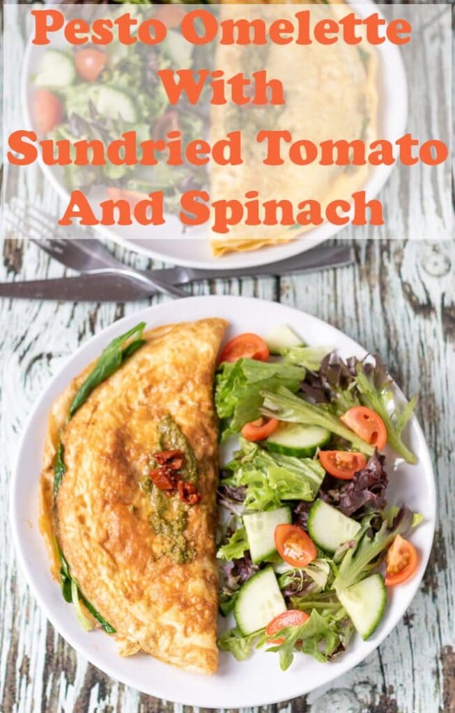 Birds eye view of a plated spinach pesto and sundried tomato omelette with a side salad. Pin title text overlay at top.