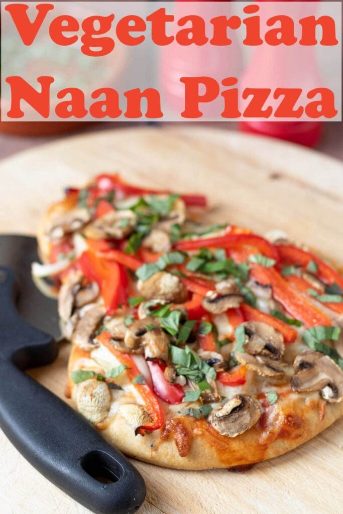 Vegetarian naan pizza on a chopping board with a pizza cutter beside it. Pin title text overlay at top.