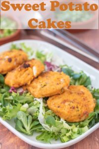 Four sweet potato cakes arranged on green lettuce on a rectangular plate. Pin title text overlay at top.