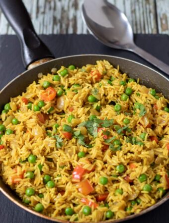 A pan of served spicy rice with peas.
