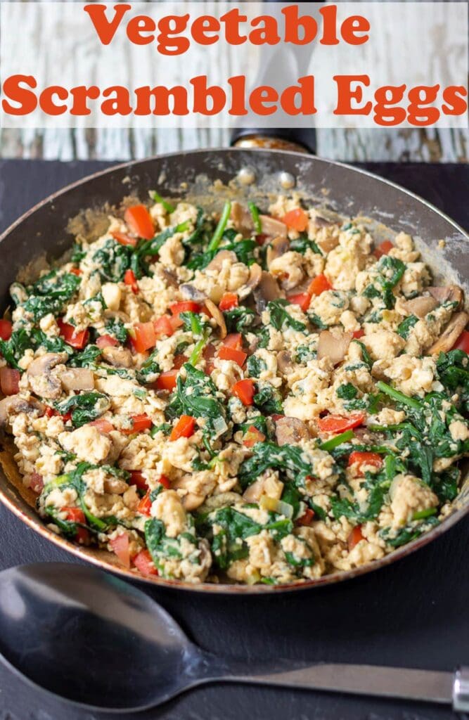 A pan of cooked vegetable scrambled eggs with a spoon in front. Pin title text overlay at top.