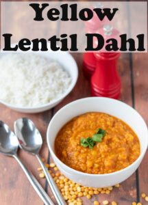 A bowl of yellow lentil dahl / dal tadka with serving spoons beside and a bowl of rice. Pin title text overlay at top.