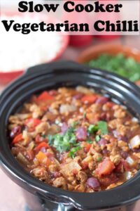 Slow cooker vegetarian chilli in slow cooker garnished with chopped coriander. Pin title text overlay at top.