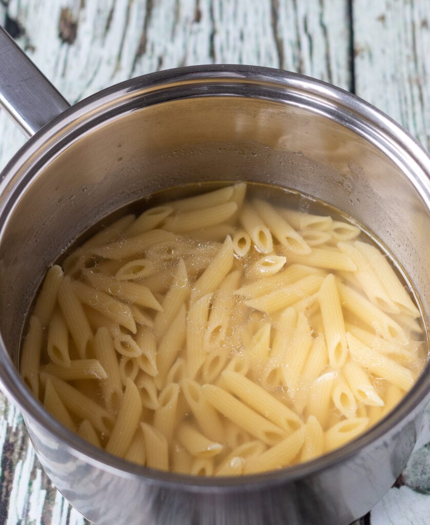 Penne pasta cooked to al-dente in a large pot.