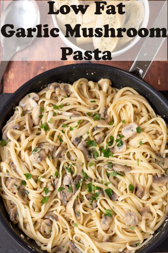 A pan of cooked low fat garlic mushroom pasta. Pin title text overlay at top.